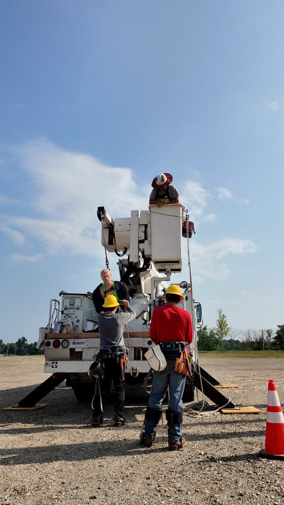 Crew working with a bucket truck in the outdoor training yard