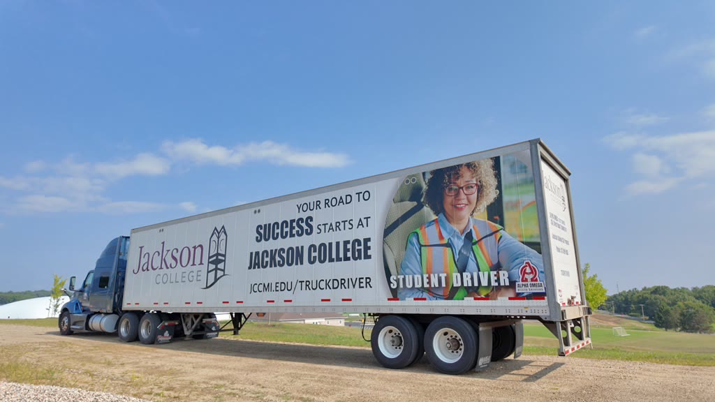 CDL training trailer with Jackson College road-to-success graphics