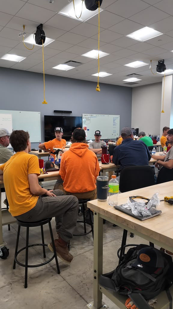 Trainees seated at workbenches during a classroom session in the training centre