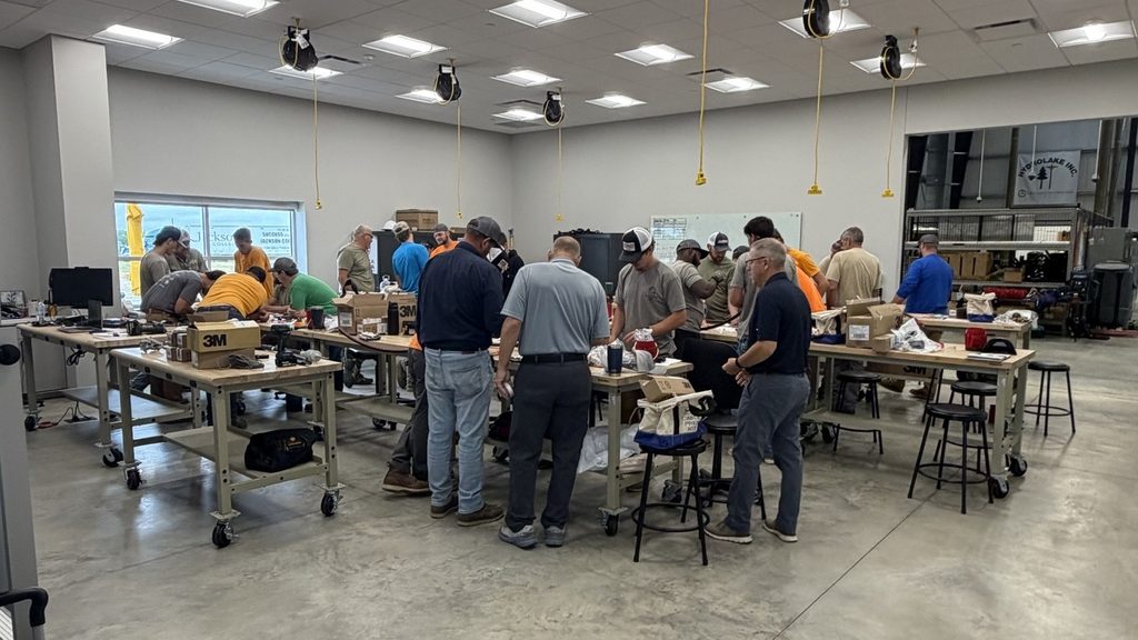 Wide view of the ATC lab with crews working at rolling benches during medium-voltage cable termination training