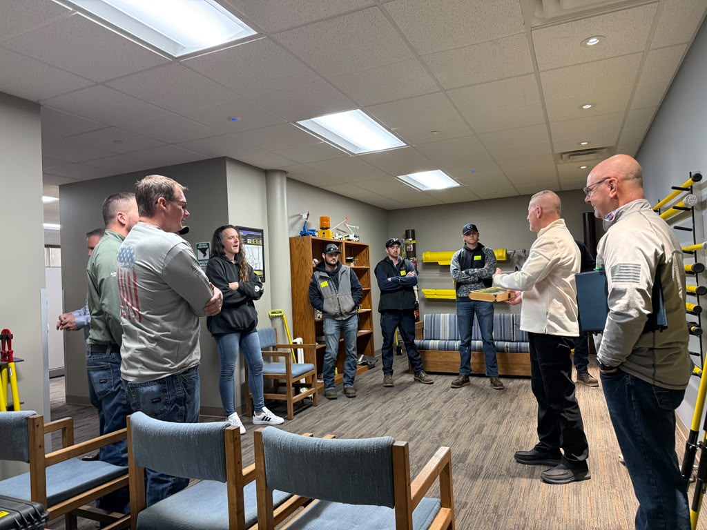 Utility crew gathered for a hands-on training session in the Alpha Omega equipment room