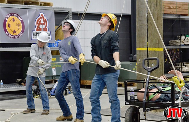 Jackson College utility students working a rope-haul drill together at the ATC